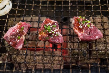 Raw beef slice charcoal on the stove, Japanese style yakiniku.