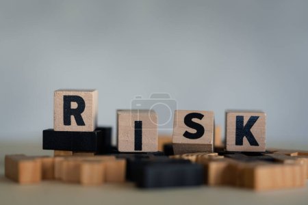 Photo for Risk assessment, decision to accept business result in uncertainty, unpredictable situation concept, cube wooden block with alphabet building the word RISK. - Royalty Free Image