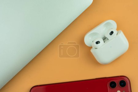 Photo for Bangkok, Thailand - December 24, 2022 : AirPods 3 generations with iPhone 11 and MacBook Pro. Headphones from the apple company. True wireless earphones - Royalty Free Image