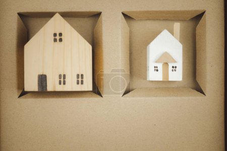 Photo for Small house and big miniature house in hole brown box. family and home concept. Property seller, buyer, agent, offering in selling, buying apartment - Royalty Free Image