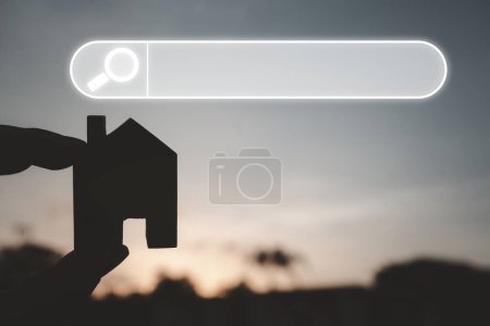 Photo for Hand holding miniature house with magnifying glass icon search on screen, choosing best house insurance, making right decision on home investment concept - Royalty Free Image