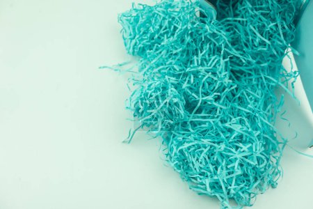 Photo for Pile of shredded paper blue color like a bird nest for filler for gifts, for protection. Close up - Royalty Free Image