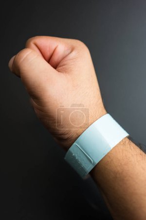 Photo for Empty concert bracelet on hand, mockup on a black background. Event ticket concept - Royalty Free Image