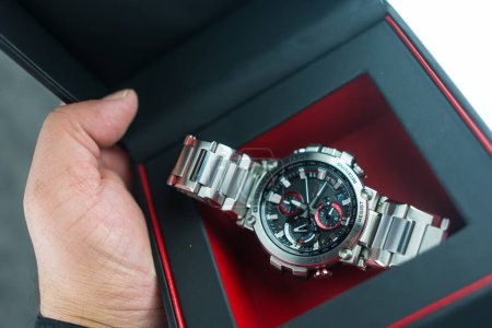 Photo for Bangkok, Thailand - February 3, 2024 : Hand holdog a box of G-Shock model MTG-B1000D-1ADR is tough watch and luxury for gentlemen who use this watch during daily routine. - Royalty Free Image