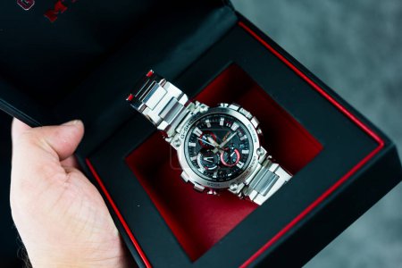 Photo for Bangkok, Thailand - February 16, 2024 : Hand holdog a box of G-Shock model MTG-B1000D-1ADR is tough watch and luxury for gentlemen who use this watch during daily routine. - Royalty Free Image