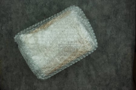 Paper box wrapped in plastic bubble wrap for protection