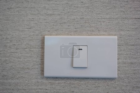 Wall switch in light interior. Modern clean apartment or home
