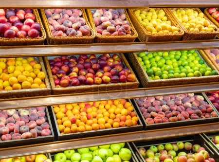 Photo for Assortment of fresh fruits on store shelves, on market counter. A large selection of fresh fruits on the market. - Royalty Free Image
