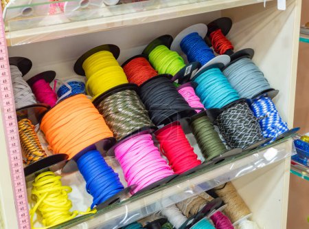 Téléchargez les photos : Des rangées de rubans colorés, des cordes et des garnitures à bobines dans un magasin d'artisanat. Bricolage, artisanat. - en image libre de droit