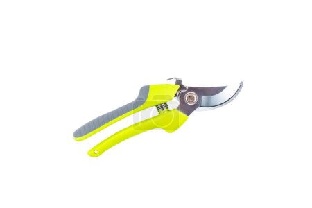 Steel gardening secateurs, scissors tool with green grip for pruning of plants and flowers, garden work, isolated on white background. Close state. Top view. Close-up.