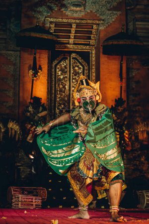 Photo for Unrecognisable Balinese artist dancing with show mask. Traditional bali cultural performance, religious dance ritual - Royalty Free Image