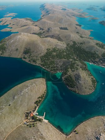 Drone aerial view of Kornati archipelago in Croatia, yacht pier and beachfront vacation homes