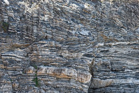 Nature force compressed cracked rock layers structure formation close-up details, in various shapes, colors, thicknesses, at south central coast of Crete, Greece. Nature, Geological science concept