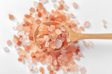 Photo for Himalayan pink salt in wooden spoon on white background - Royalty Free Image