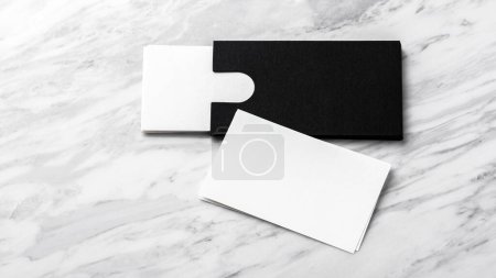 Photo for Business card mockup with black paper card holder on white marble background - Royalty Free Image