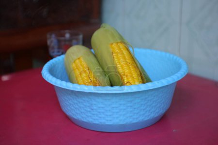 Photo for Boiled corn in a blue container. good for people with diabetes - Royalty Free Image