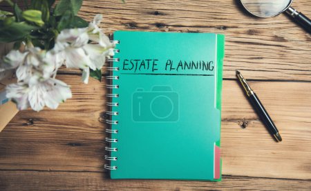 estate planning on notepad and pen on table