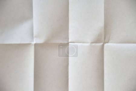 Foto de A clean white sheet of paper, folded four times. Blank for you caption - Imagen libre de derechos
