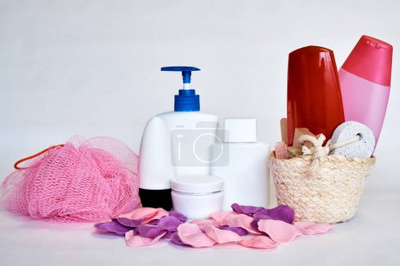 Foto de Una toalla y un conjunto de cremas para los procedimientos de spa sobre un fondo blanco. Cremas, aceites, champús. - Imagen libre de derechos