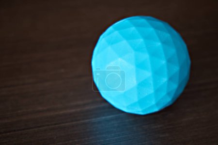 Photo for Blue massage ball isolated on dark background. - Royalty Free Image