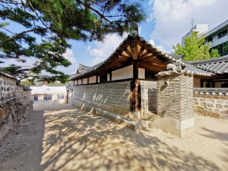Photo for Traditional Korean Hanok Village building with old wooden buildings and stone wall in the afternoon in Seoul, South Korea - Royalty Free Image