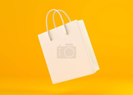 Foto de Bolsa de compras vacía de color blanco volando sobre el fondo amarillo, texto de espacio de copia, concepto creativo. ilustración de renderizado 3d - Imagen libre de derechos