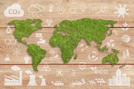 Photo for Ecology concept: sustainable World. A green grass textured World map above a brown wood planks panel, with several white ecology icons superimposed on background. - Royalty Free Image