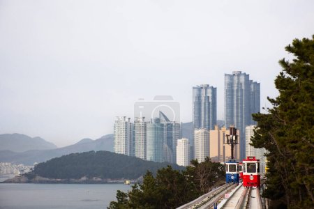 Téléchargez les photos : Les Coréens et les voyageurs étrangers assis sur Sky Capsule Tram Haeundae Blue Line à la station Mipo pour une visite de voyage au parc Haeundae Beach le 18 février 2023 à Busan, Corée du Sud - en image libre de droit