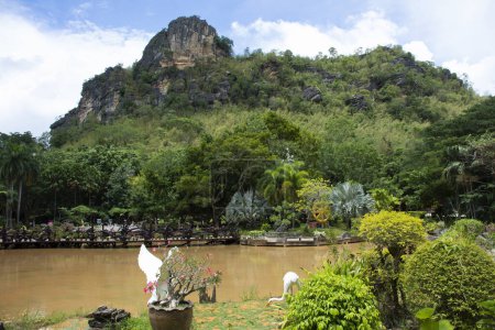 Photo for View landscape lake mountain and gardening garden for thai travelers people travel visit and rest relax park with fresh environment in Wat Tham Khao Wong Temple at Ban Rai city in Uthai Thani Thailand - Royalty Free Image
