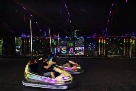 Photo for Electricity powered bumper cars or dodgems toy car for thai family people and children kid playing amusement carnival park in at temple annual festival on October 1, 2023 in Nonthaburi, Thailand - Royalty Free Image