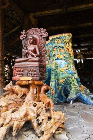 Art sculpture carving wooden ancient buddha god and wood antique deity angel for thai people travel visit respect praying blessing of Wat Tham Khao Prathun Temple at Ban Rai in Uthai Thani, Thailand