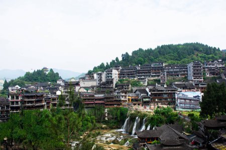 Photo for Cityscape historic building antique architecture of Furong Zhen Tujia ancient town with landscape mountain waterfall and youshui river for chinese travelers travel visit on May 9, 2024 in Hunan, China - Royalty Free Image