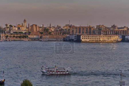 Photo for Luxor ,Egypt sunset shot from west bank showing Nile river with  Feluccas, cruise ships  and Luxor Temple in East bank - Royalty Free Image