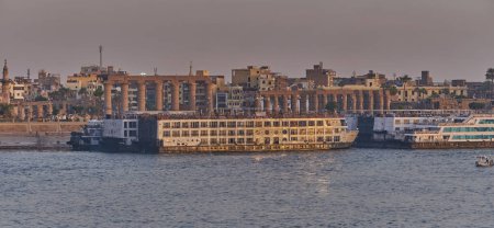Photo for Luxor ,Egypt sunset shot from west bank showing Nile river with  Feluccas, cruise ships  and Luxor Temple in East bank - Royalty Free Image