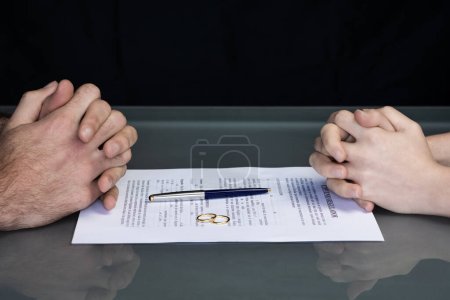 Foto de Couple goes through divorce signing papers. High quality photo - Imagen libre de derechos