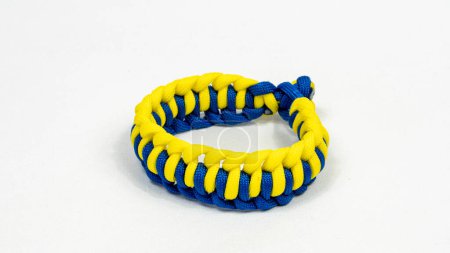 Photo for Braided paracord bracelet on a white background. Handmade, creative design. - Royalty Free Image