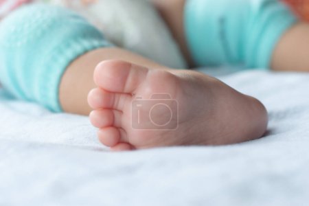 Close-up of the baby's soft feet on the mattress