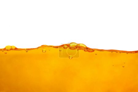 Orange water surface with bubbles and water splashes on white background isolated