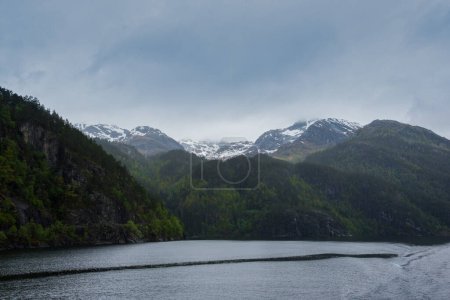 Snow peaked mountains in the fjords of Norway