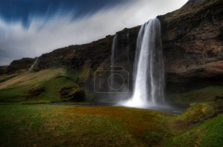 Seljalandsfoss is a waterfall in Iceland. The Seljalands river, the 'liquid river', drops about 60 meters.