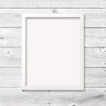 8x10 white vertical frame with empty poster against a modern wood plank background. Includes clipping path to make it easy to add your design to the frame.