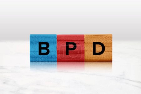 Photo for Closeup of colored wooden tiles spelling out BPD. - Royalty Free Image