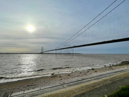 Photo for Humber Bridge in Hull, England, UK. Tide coming into the estuary - Royalty Free Image