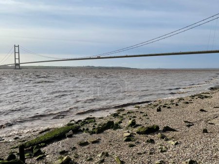 Photo for Humber Bridge in Hull, England, UK. Tide coming into the estuary - Royalty Free Image