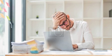 Serious Businessman Working At Laptop Computer Typing Something In Office. Business Career Concept. Copy Space..