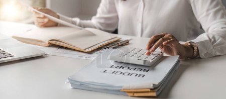 Photo for Accountants are using calculators for tax calculations, finance and financial planning of the office.. - Royalty Free Image