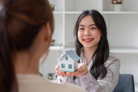 Venta de casas y agente de bienes raíces proporcionan modelos caseros a los clientes para completar el contrato de venta con..