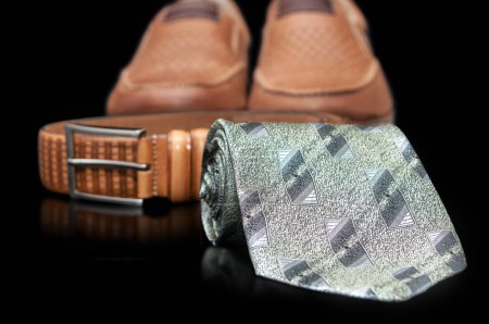 Photo for Neck tie, strap and shoes  isolated on a black background - Royalty Free Image