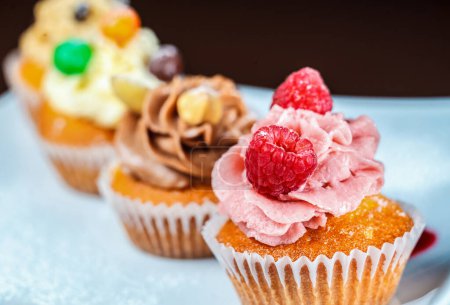Photo for A luscious, freshly-baked cupcake with an abundance of berries and sweet icing, tempting all who see it. - Royalty Free Image