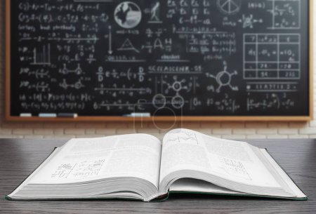 Photo for An open textbook lies on a wooden desk in the foreground with a blurred background featuring a blackboard covered in various mathematical equations and diagrams. - Royalty Free Image